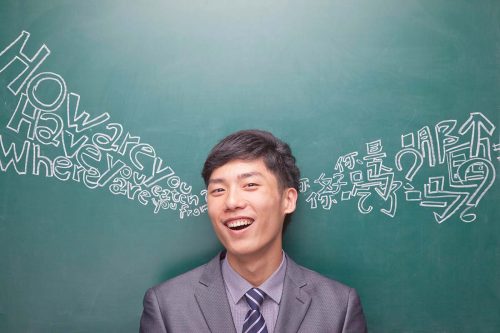 Words in multiple languages on a blackboard, symbolizing the global opportunities and bilingual advantages in jobs