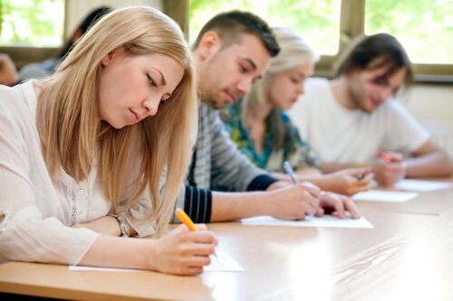 Students answering an exam correctly thanks to knowing how to design assessment tools for english teachers.