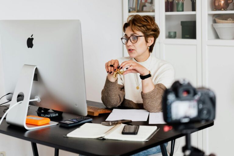 An ESL teacher using a computer at her desk and researching effective tips for choosing ESL materials for her diverse students.